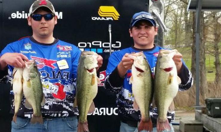 Two students from fishing club holding fish